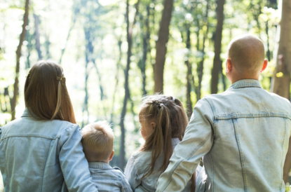 man-and-woman-holding-hands-together-with-boy-and-girl-looking-at-green-trees-during-day.jpg man and woman holding hands together with boy and girl looking at green trees during day